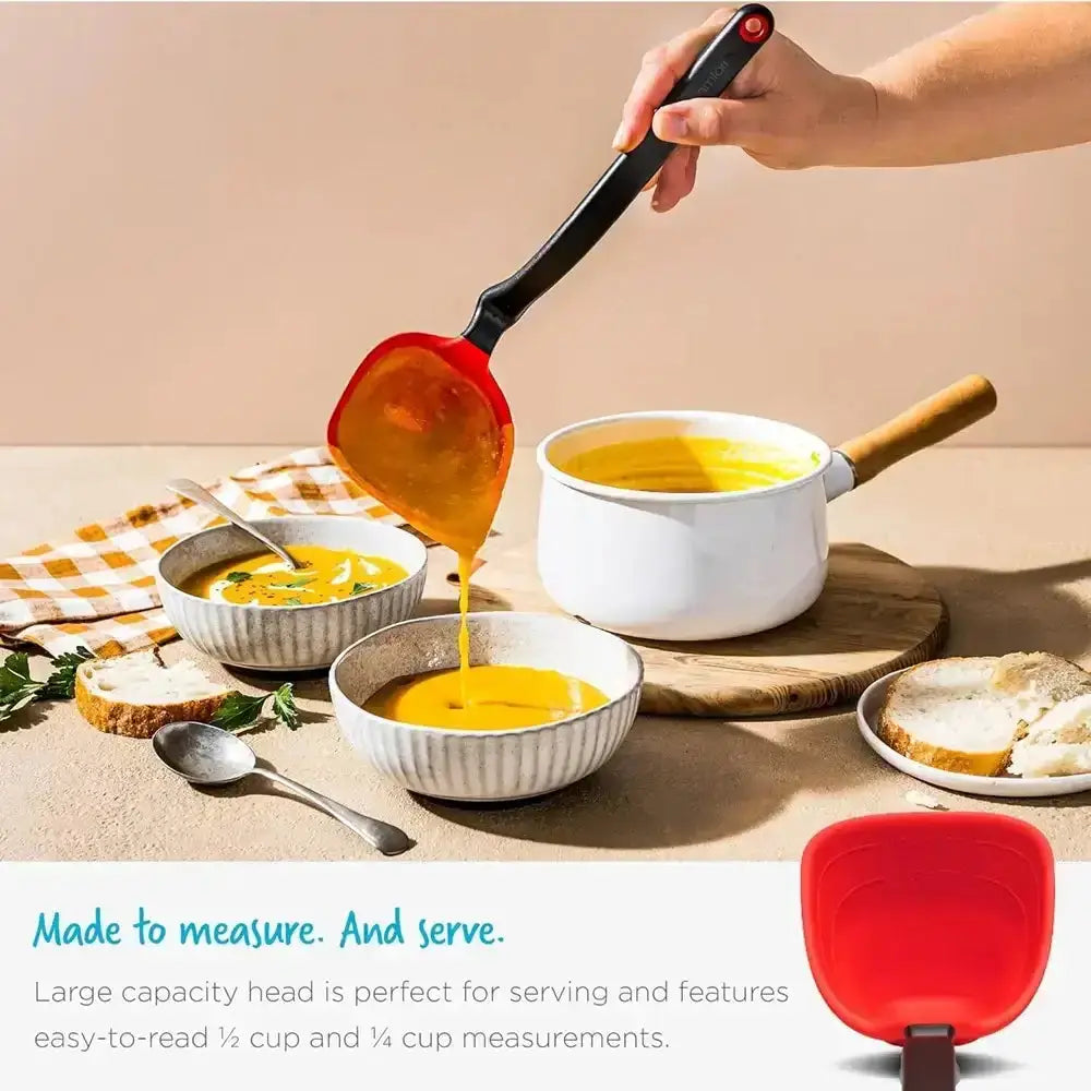 Red measuring spoon being used to serve soup into bowls on a wooden table.