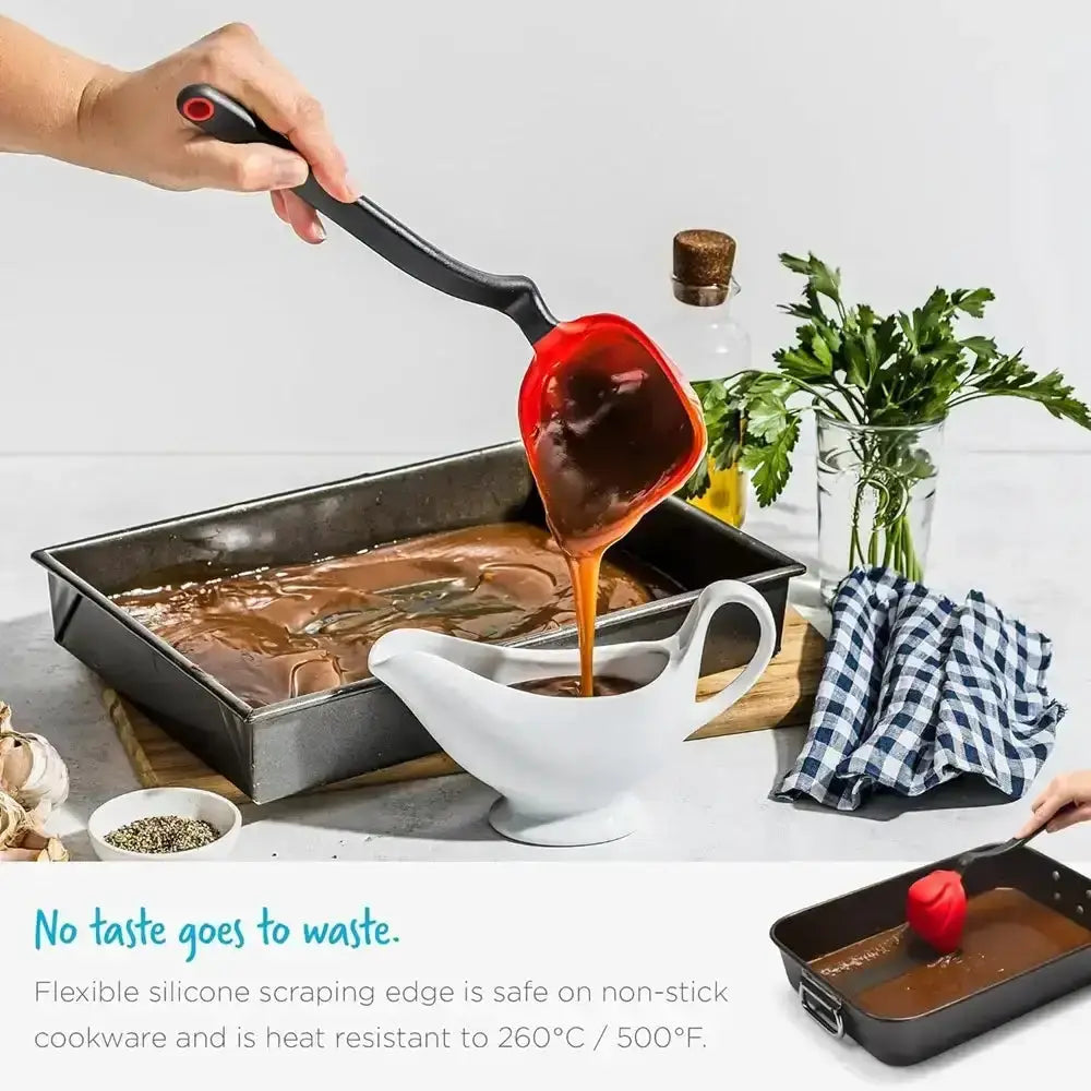 Person using a flexible silicone spatula to scrape sauce from a pan into a white bowl on a kitchen counter.