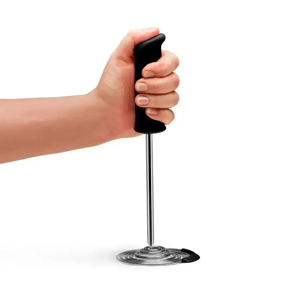 Hand holding Dreamfarm Smood Masher with black handle, premium kitchenware at Cookin Stores.