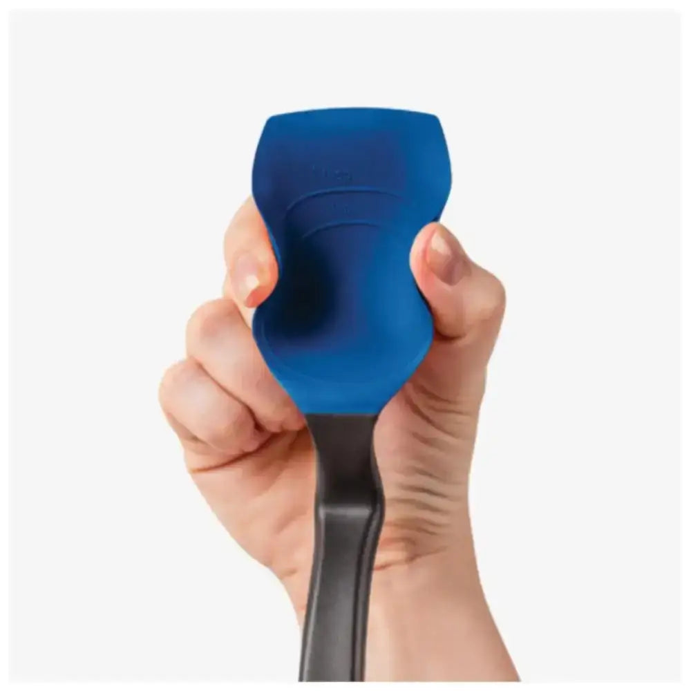 Hand holding blue silicone kitchen spoon with ergonomic black handle