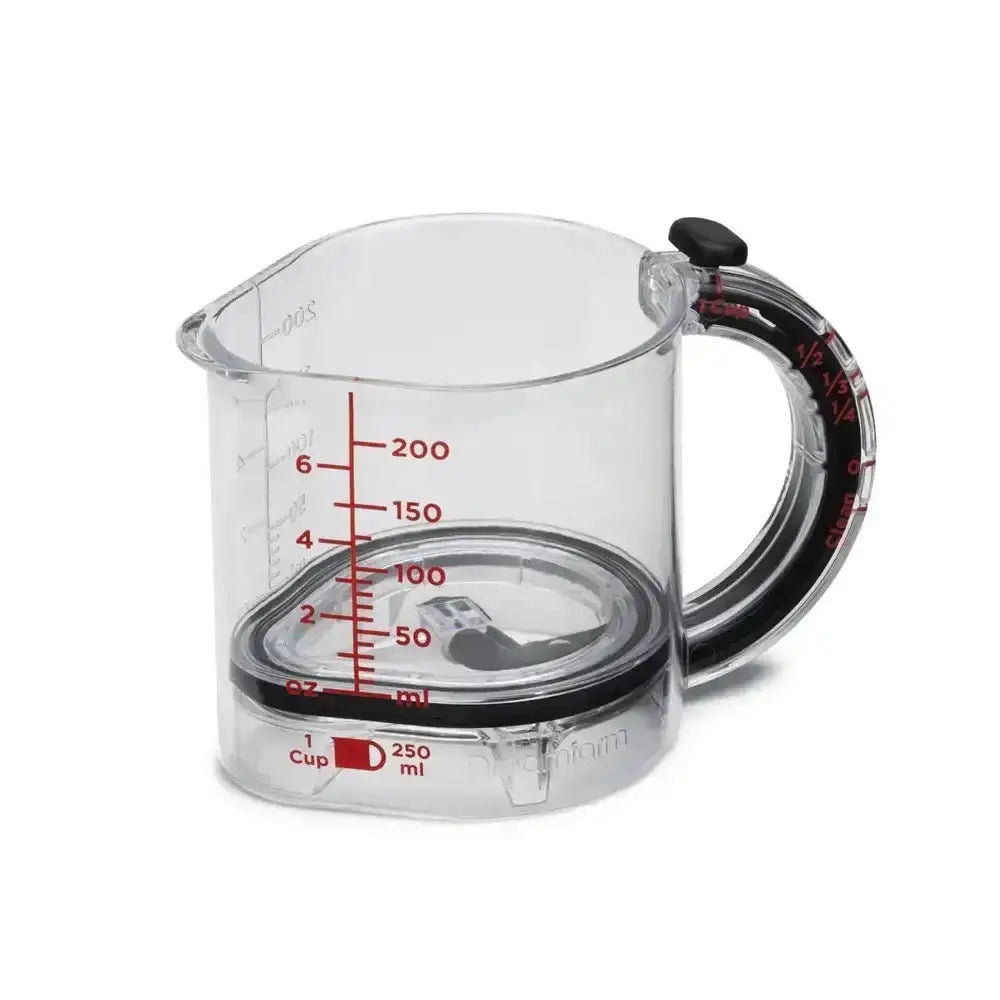 Clear measuring cup with red measurement markings on a white background