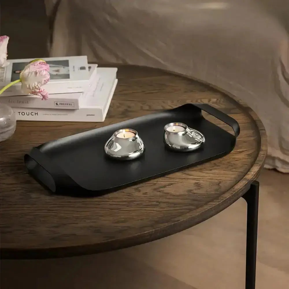 Eva Solo stainless steel serving tray in black with two candle holders on wooden table, Cookin Stores
