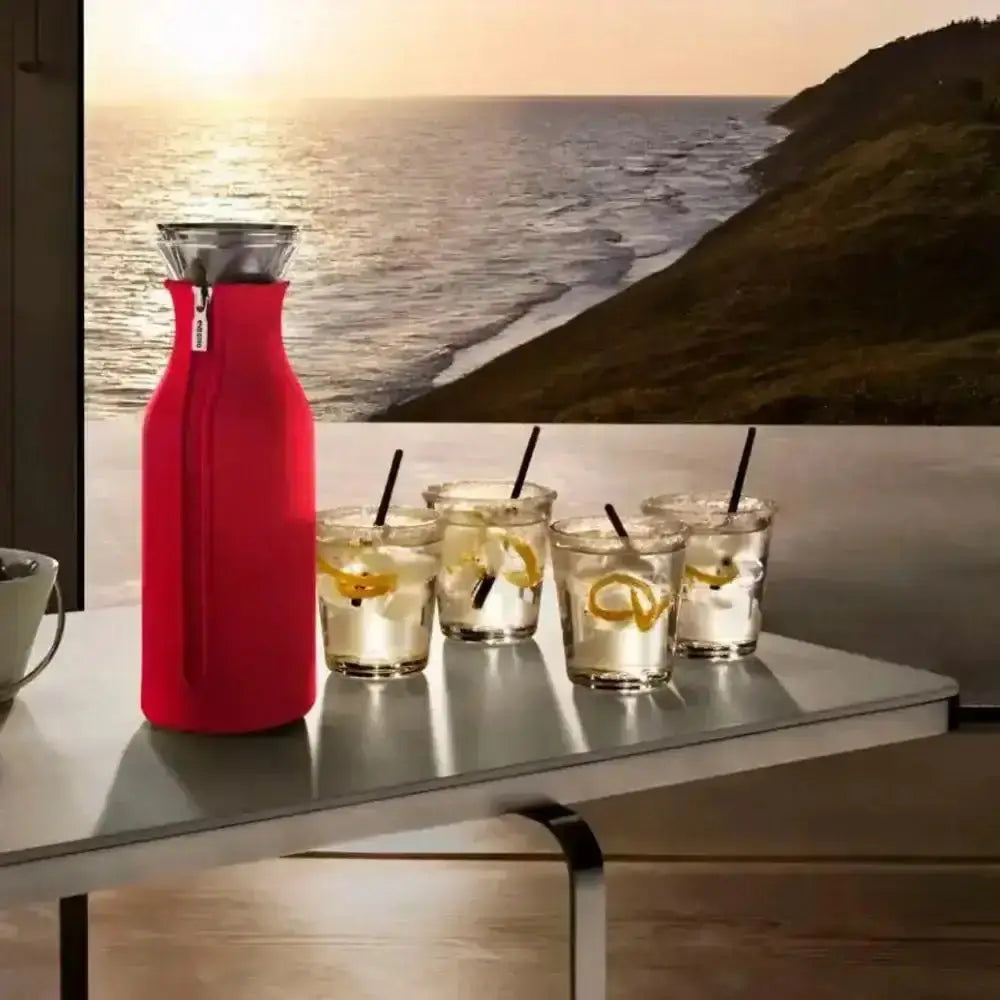 Eva Solo drinking tumblers set of 6 with drinks on table beside a red carafe, sunset view, Cookin Stores kitchenware