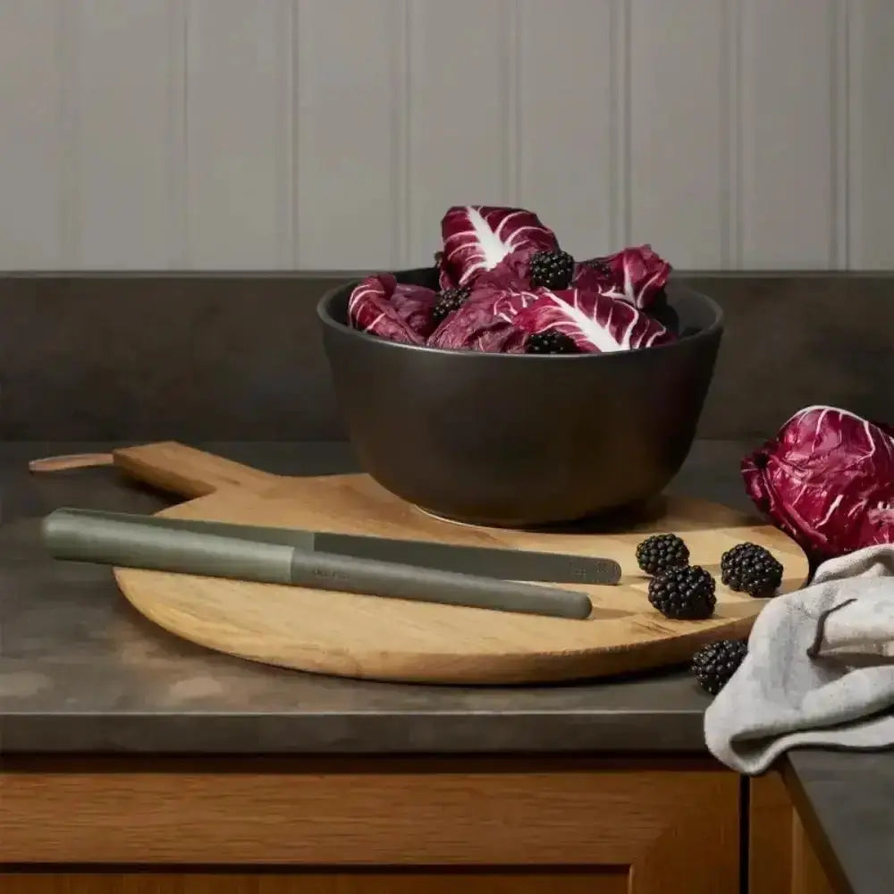 EVA Solo Green Tools Food Tweezer on wooden board, black bowl with radicchio and blackberries on kitchen counter at Cookin Stores