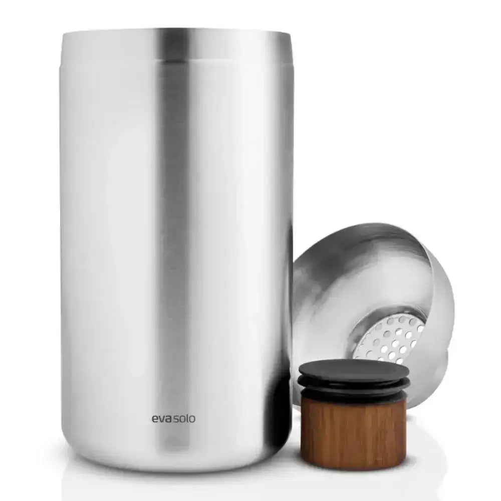 Stainless steel shaker with wooden cap and metal strainer on a white background, featuring the Eva Solo brand.