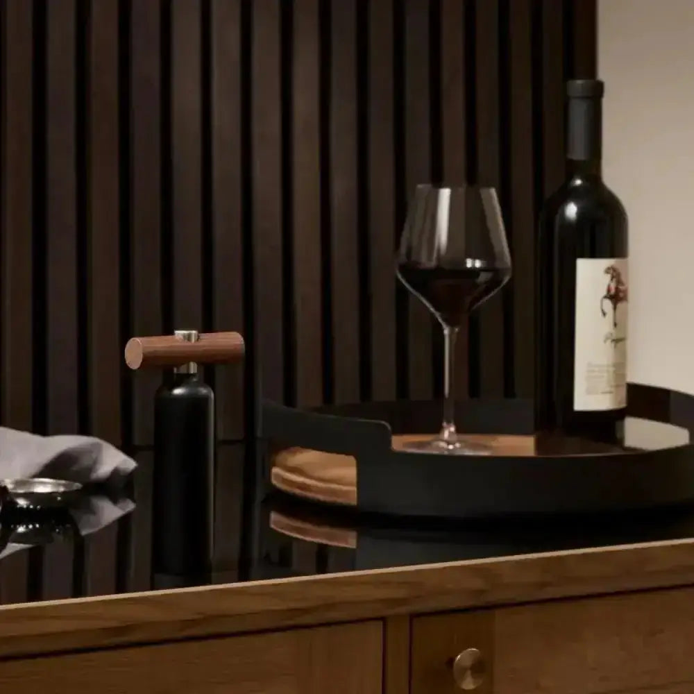 Eva Solo Liquid Lounge corkscrew in black wood finish on modern kitchen counter with wine bottle and glass, Cookin Stores premium kitchenware.