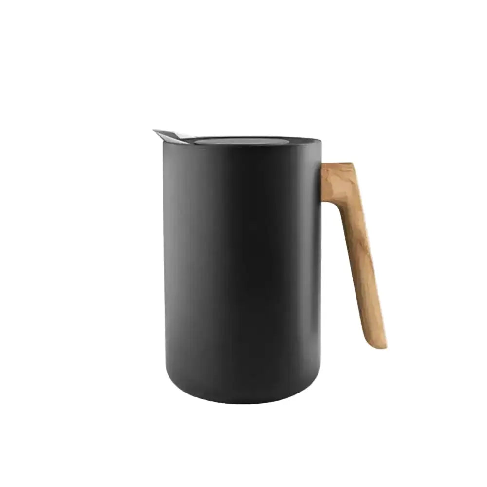 Black milk pitcher with a wooden handle on a white background