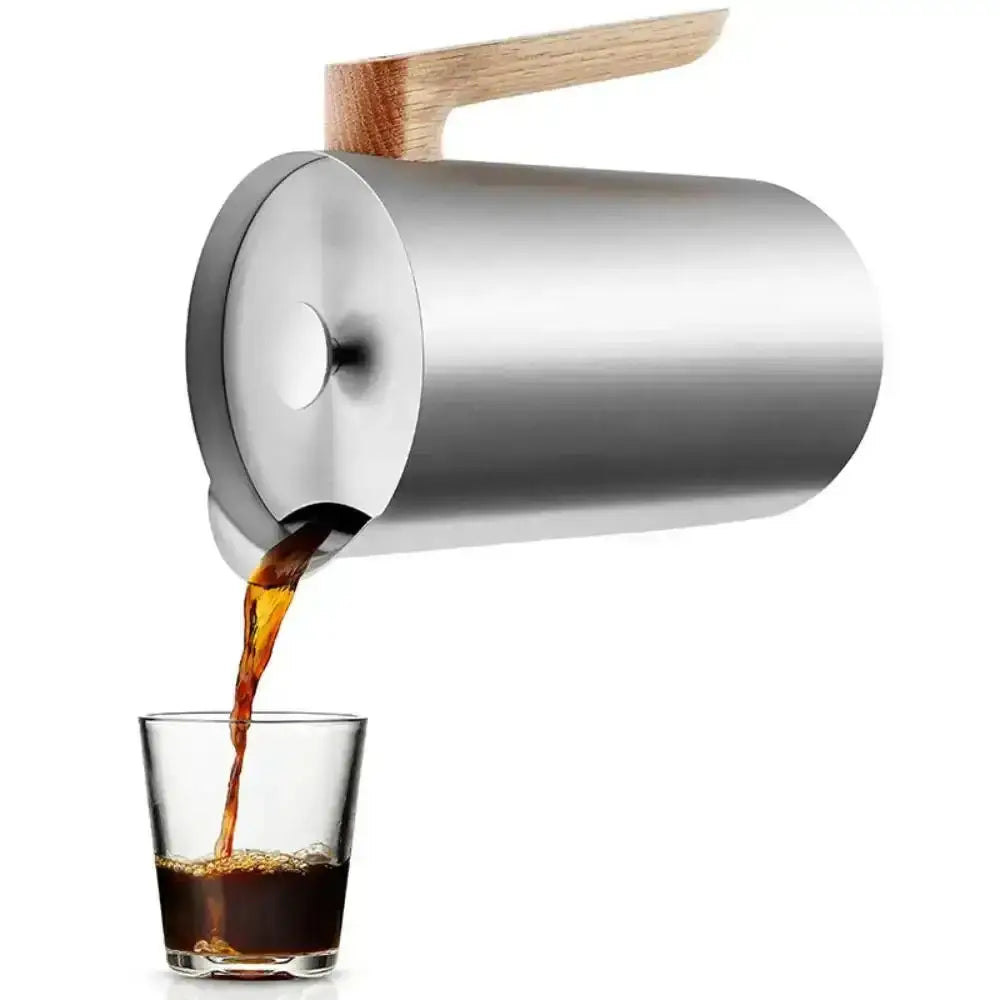 Stainless steel Nordic thermos cafetiere pouring coffee into a glass, modern kitchenware