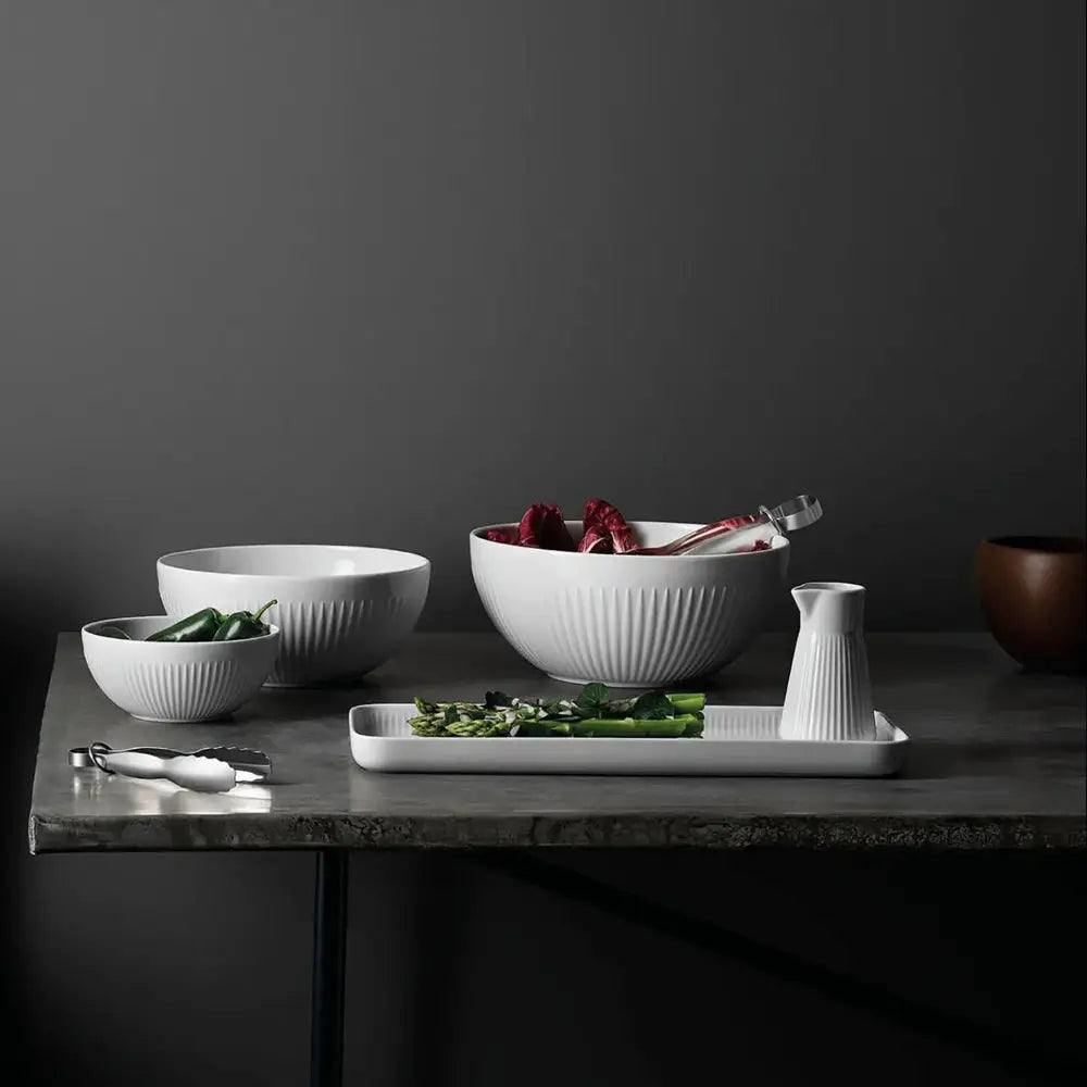 Dining setup with bowls, a chair, and a dark wall background