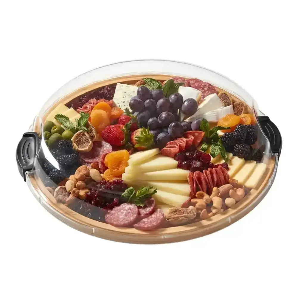 Round charcuterie board with various meats, cheeses, fruits, and nuts on a white background