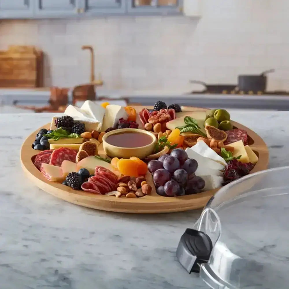 Round wooden Farberware Build-a-Board bamboo lazy Susan 35cm with assorted cheeses meats fruits nuts and dipping sauce