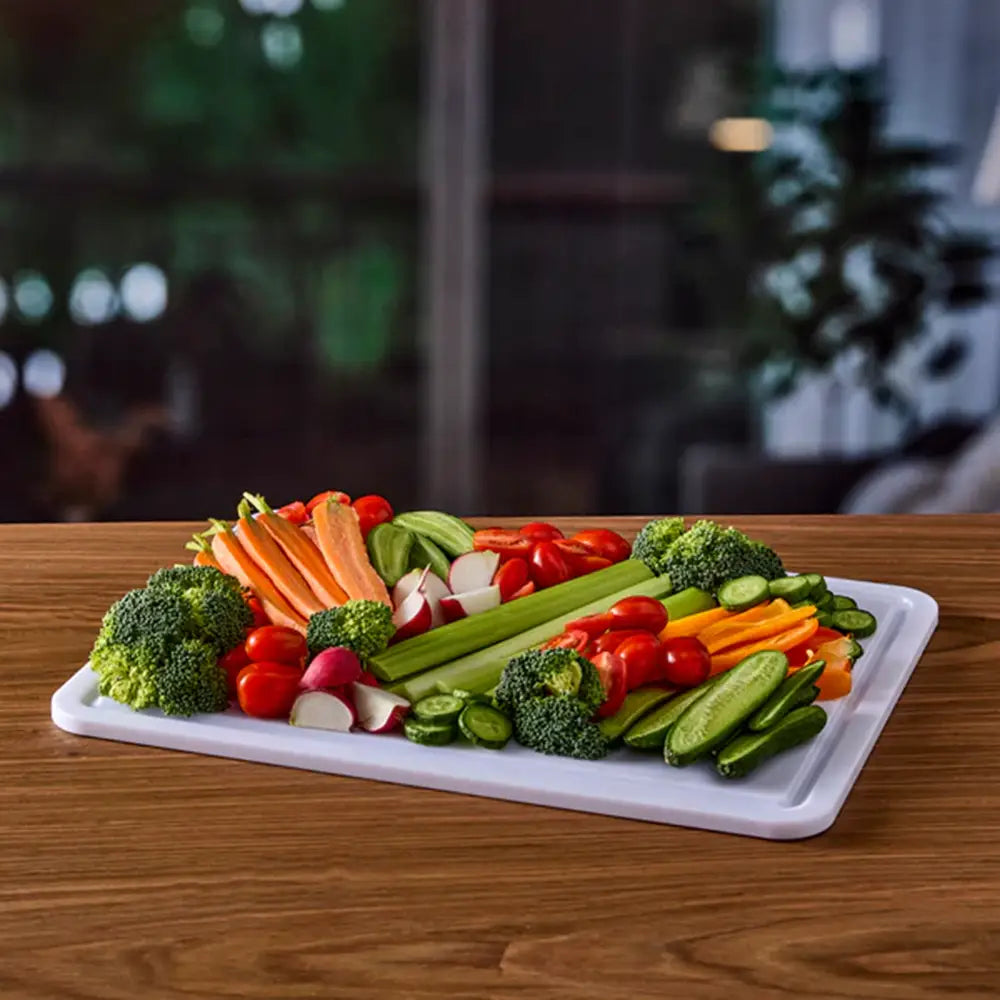 Assorted vegetables on a white cutting board with a blurred background