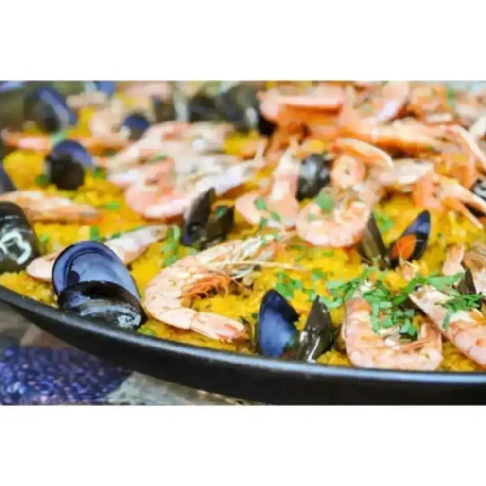Seafood dish with shrimp and mussels in a pan on a white background