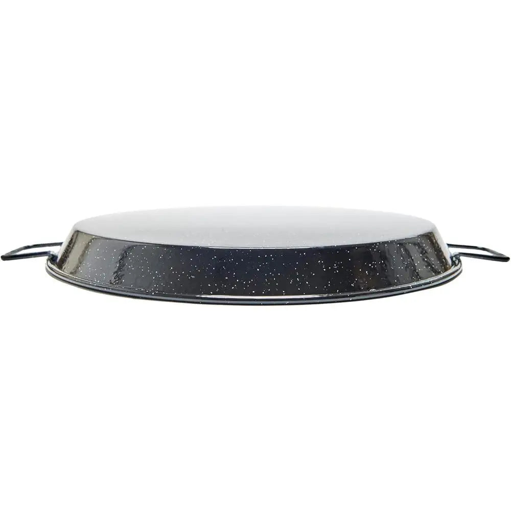 Round metal paella pan with speckled black and white design on a white background