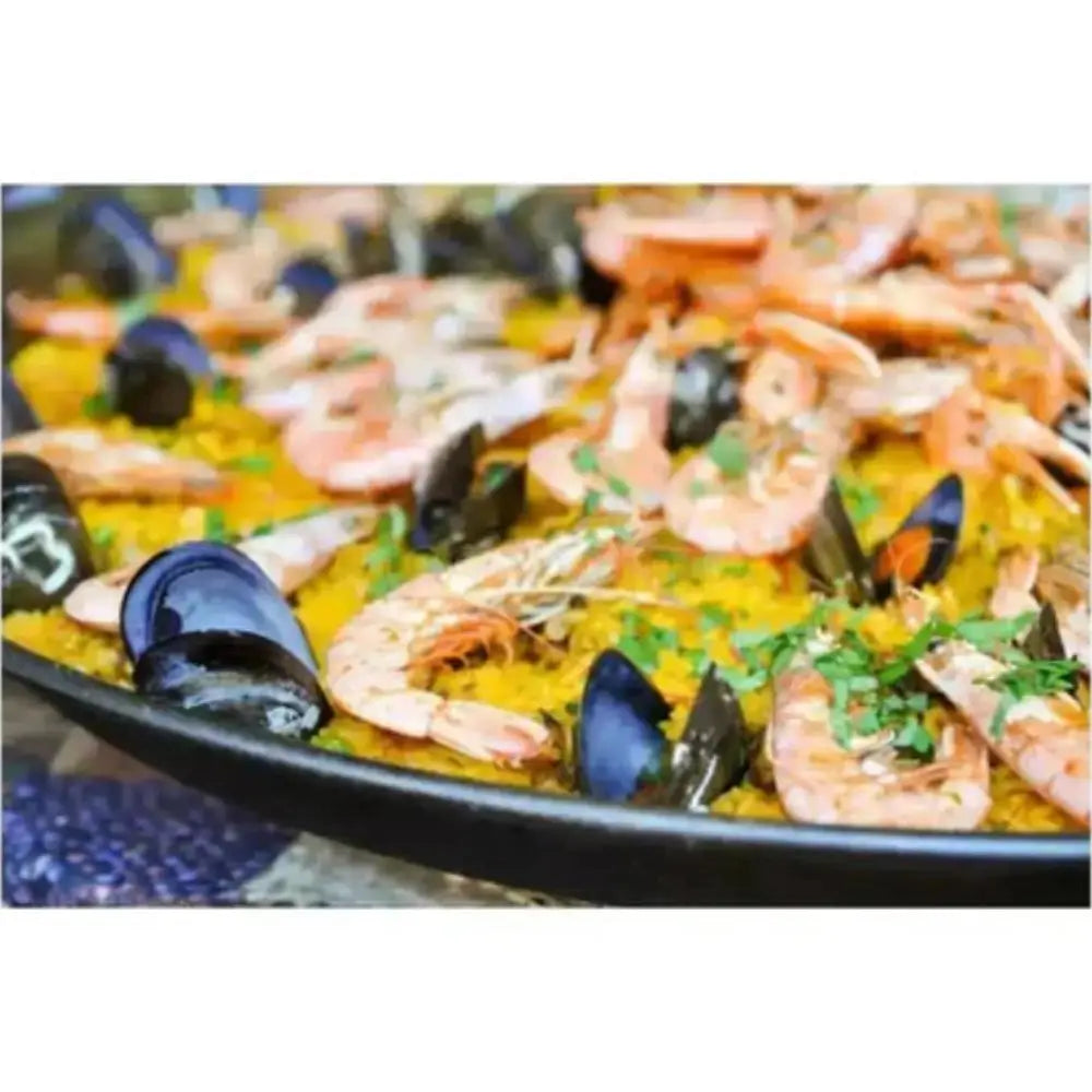 Seafood dish with shrimp and mussels in a pan on a white background