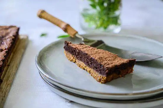 Slice of chocolate tart on plate with serving utensil, premium kitchenware from Cookin Stores