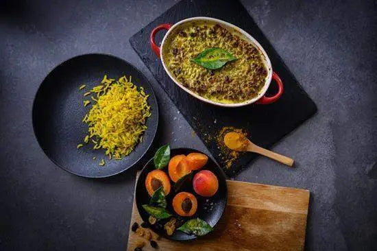 Cookin Stores kitchenware with baked casserole, turmeric, fresh apricots, and yellow rice