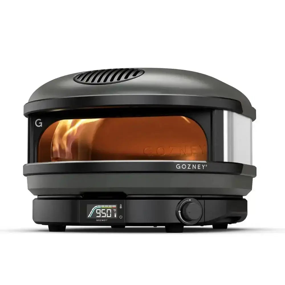 Black gozney arc 14 inch compact outdoor pizza oven with digital display at 950 degrees and glass door showing glowing interior