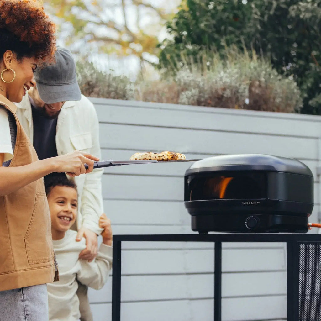Black gozney arc lite pizza oven with sleek modern design and visible flame showcasing gozney’s signature arc lite pizza features