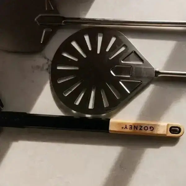 Gozney Balance Turning Peel 90cm with wooden handle on marble surface, premium kitchenware at Cookin Stores.