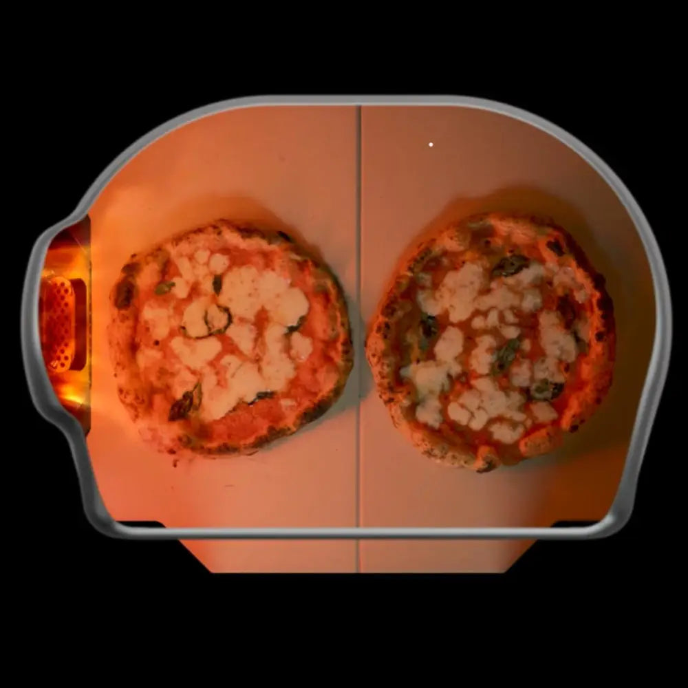 Two pizzas with different toppings in a pizza oven