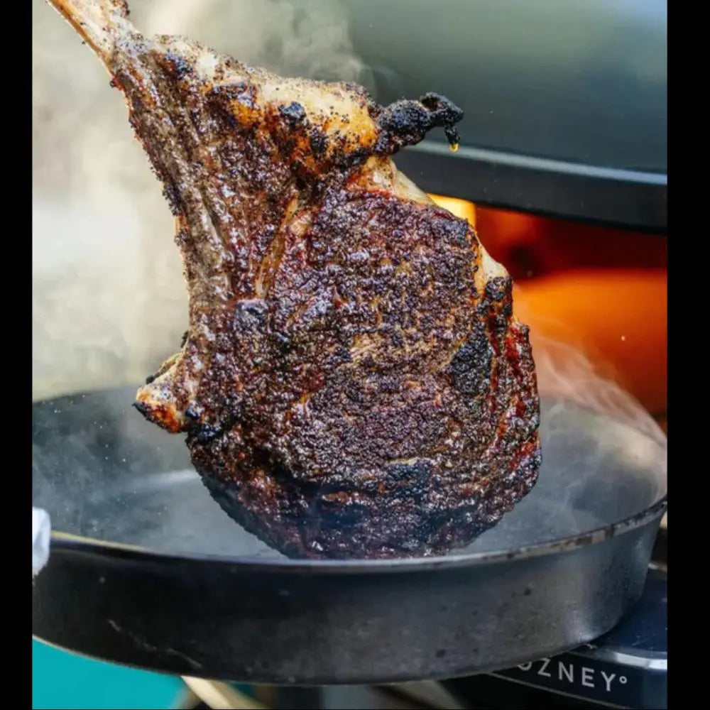 Grilled steak on a pan with a blurred background