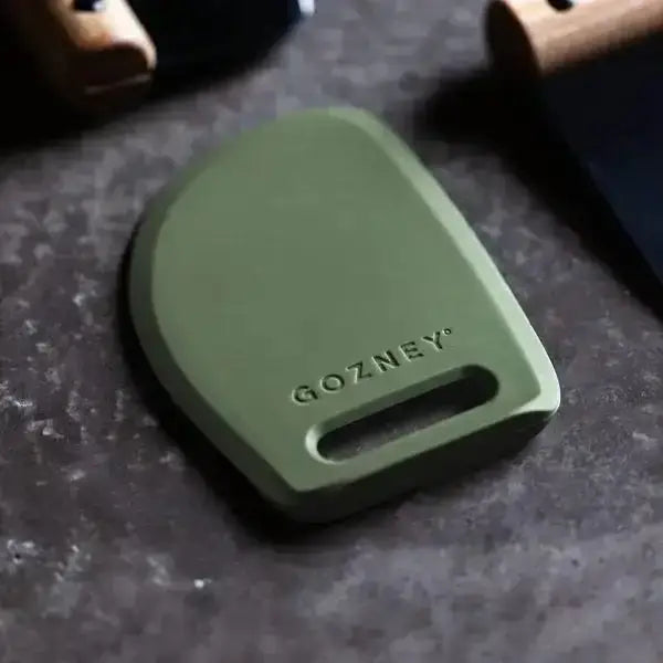 Gozney pizza dough scraper in olive green on a kitchen countertop, premium kitchenware at Cookin Stores