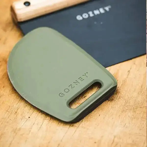Gozney pizza dough scraper on wooden surface, premium kitchen tool at Cookin Stores