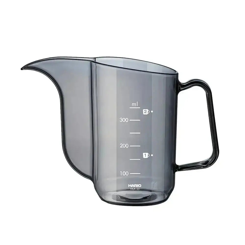 Gray measuring cup with black handle and measurement markings on a white background