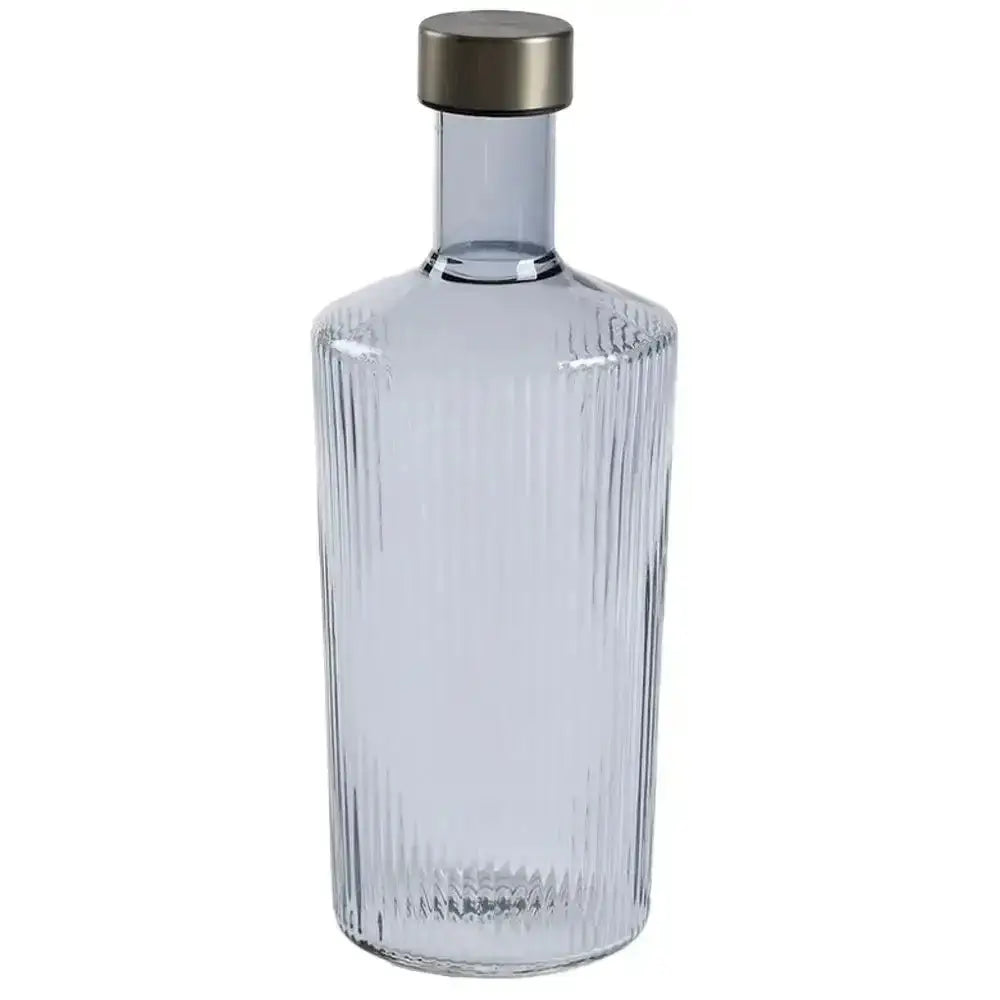 Clear glass bottle with ribbed design and metallic cap on a white background