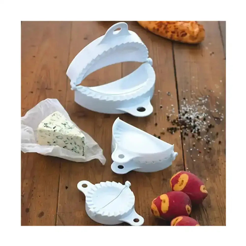 Set of white pasta makers on a wooden surface with ingredients.