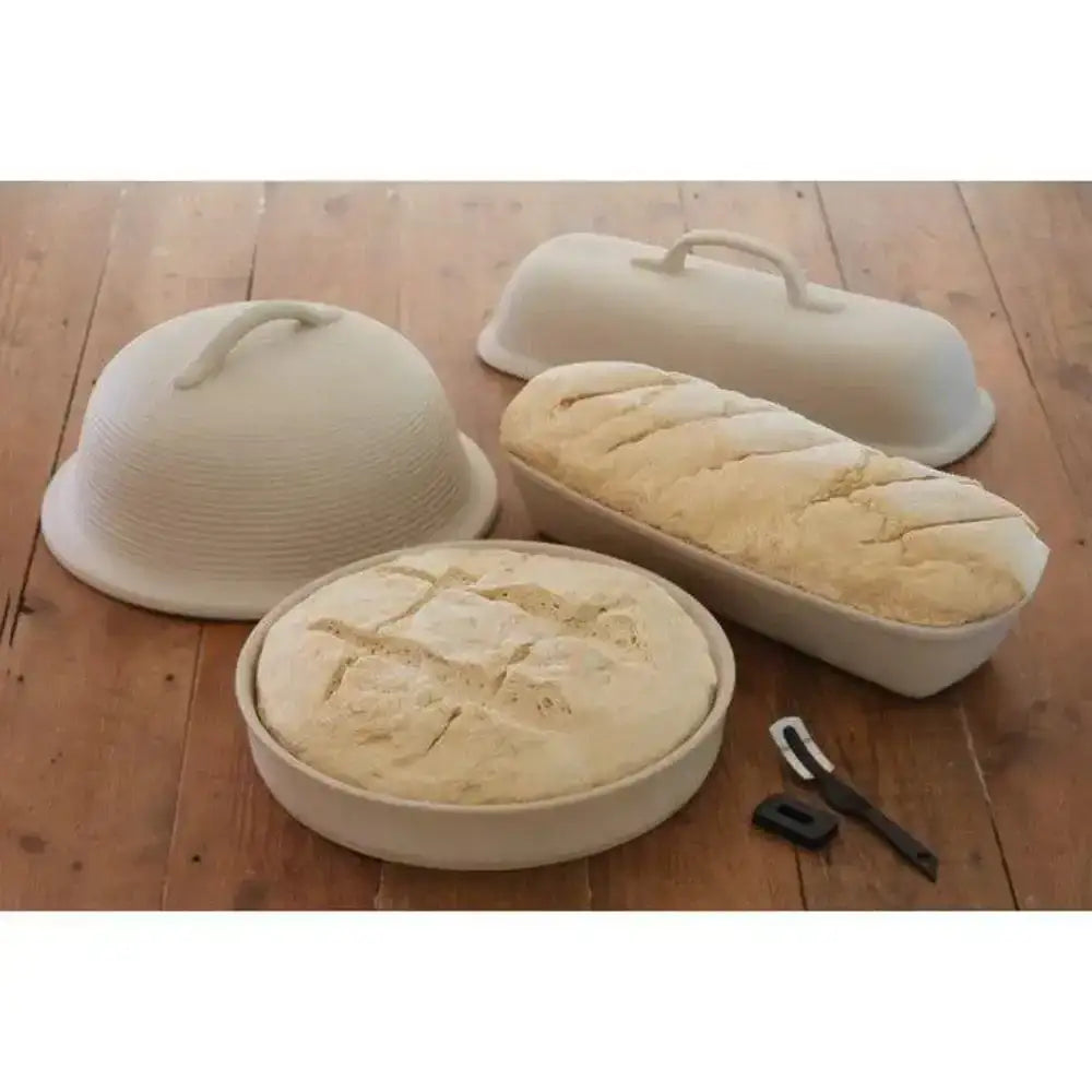 Set of bread-making molds with bread on a wooden surface