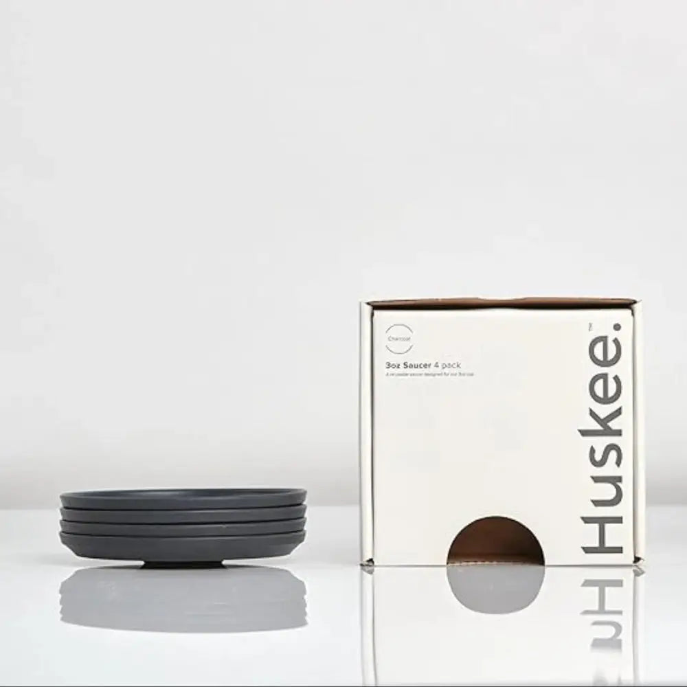 Set of charcoal bowls with their packaging on a white background