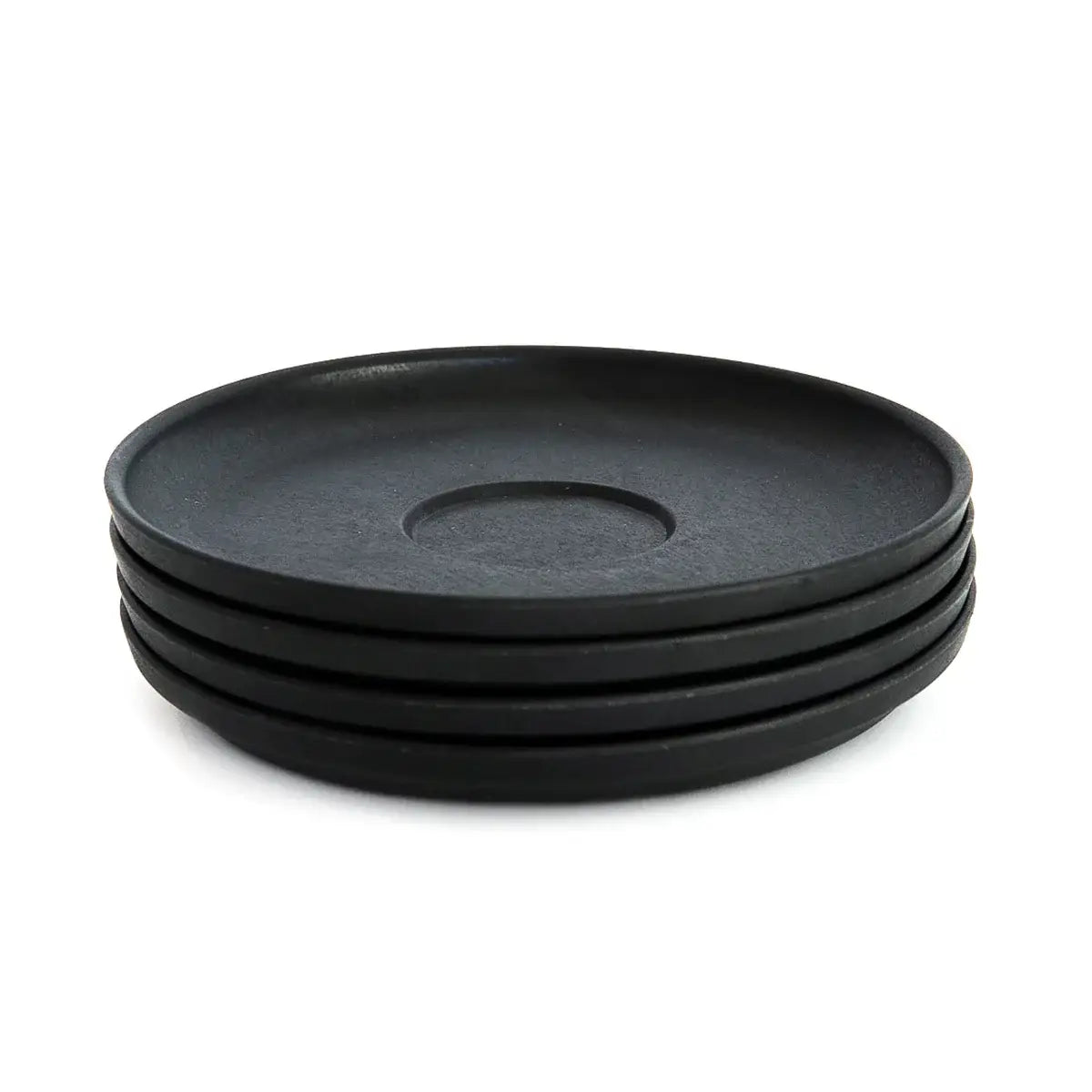 Stack of four huskee charcoal espresso matte black ceramic saucers with recessed wells made from repurposed coffee husks