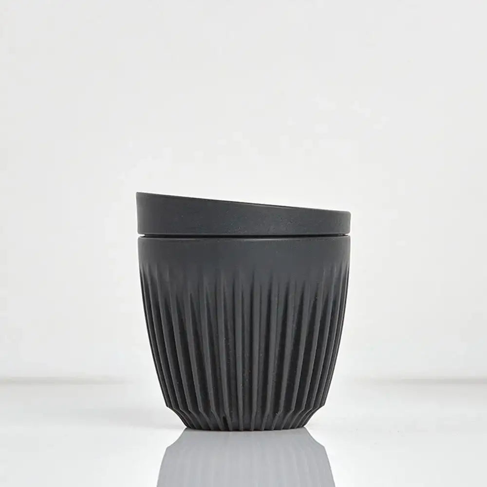 Black textured cup on a white background