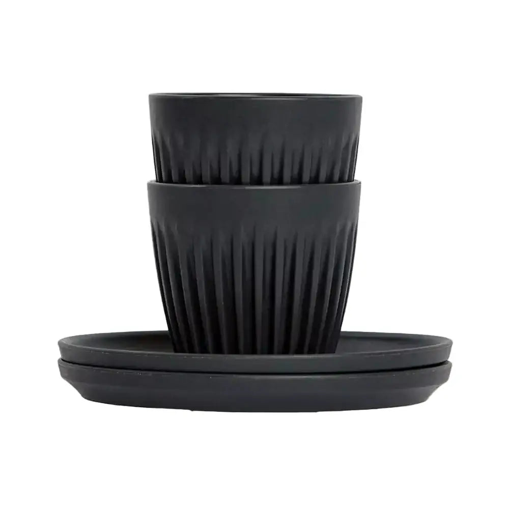 Set of two espresso cups and saucers on a white background