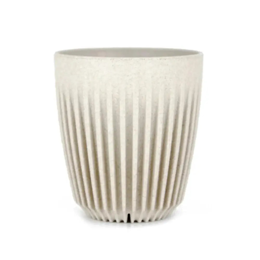 Beige fluted coffee cup on a white background