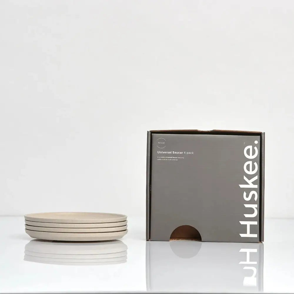 Set of beige saucers with a Huskee box on a white background