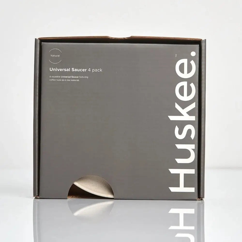 Huskee packaging box with a beige universal saucer on a white background