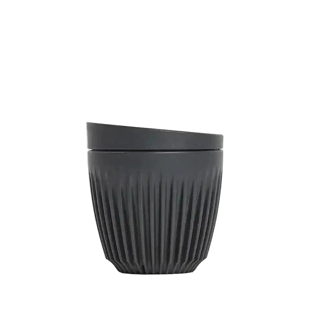 Black textured cup on a white background