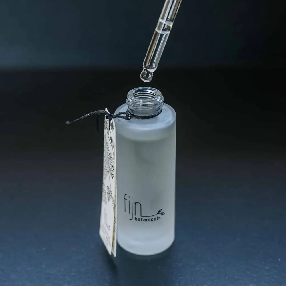 Fijn Botanicals dropper bottle with dropper on a dark background