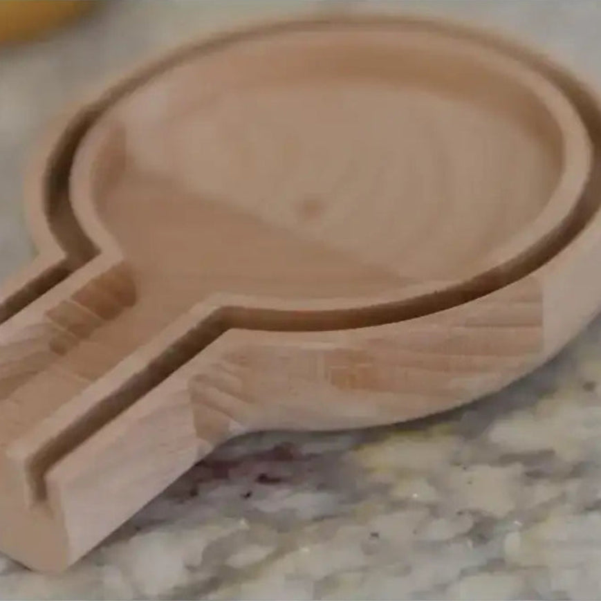 Wooden spoon rest on a marble surface