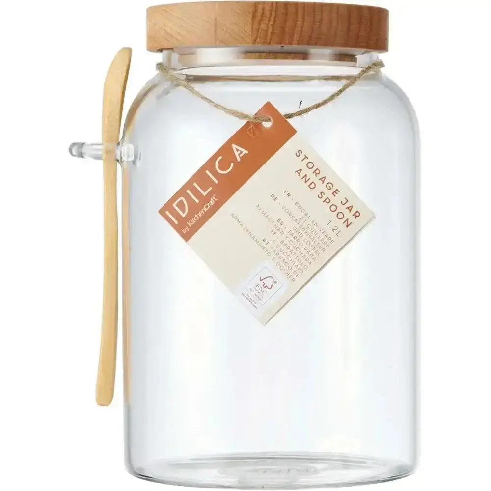 Clear glass storage jar with wooden lid and handle, featuring an 'Idilica' label.