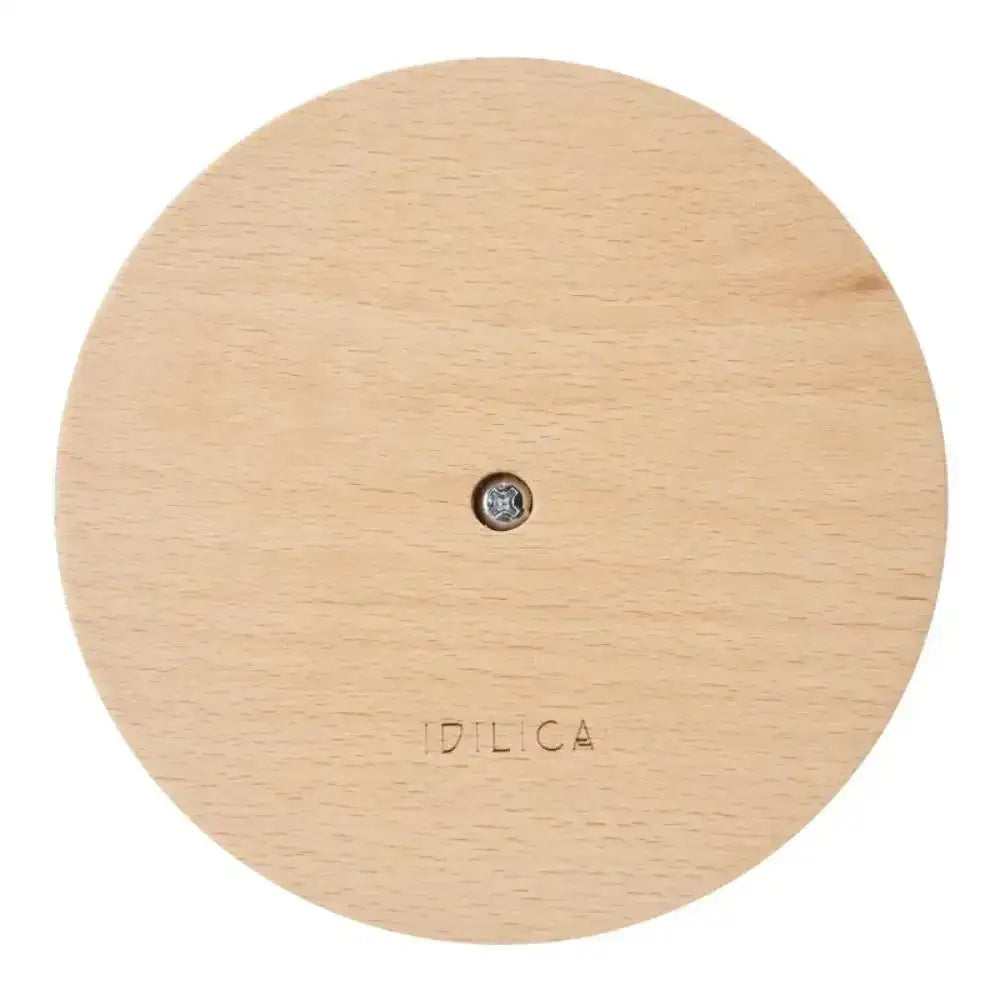 Round wooden product with 'Idilica' branding on a white background