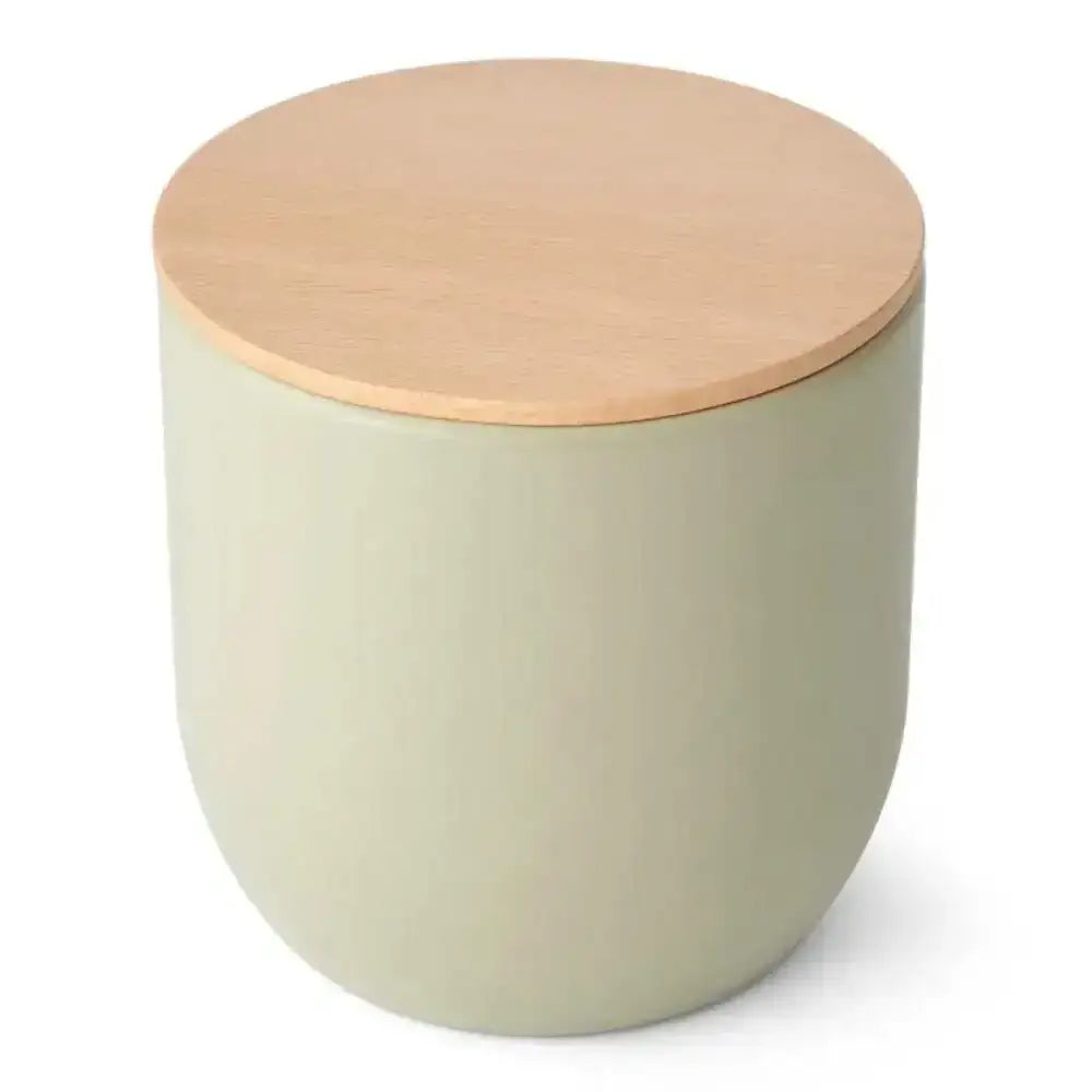 Round green container with a wooden lid on a white background