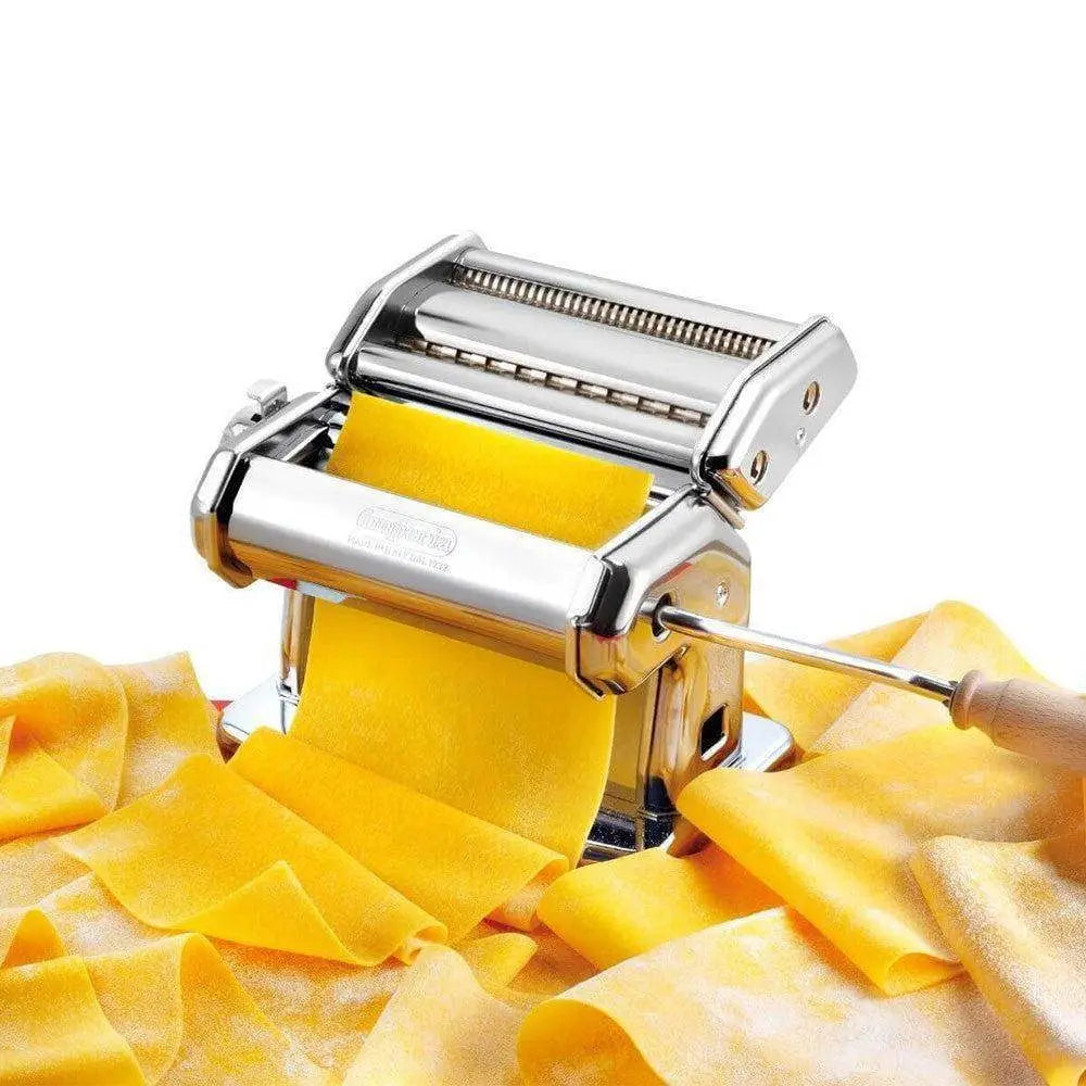 Pasta maker with fresh yellow pasta sheets on a white background