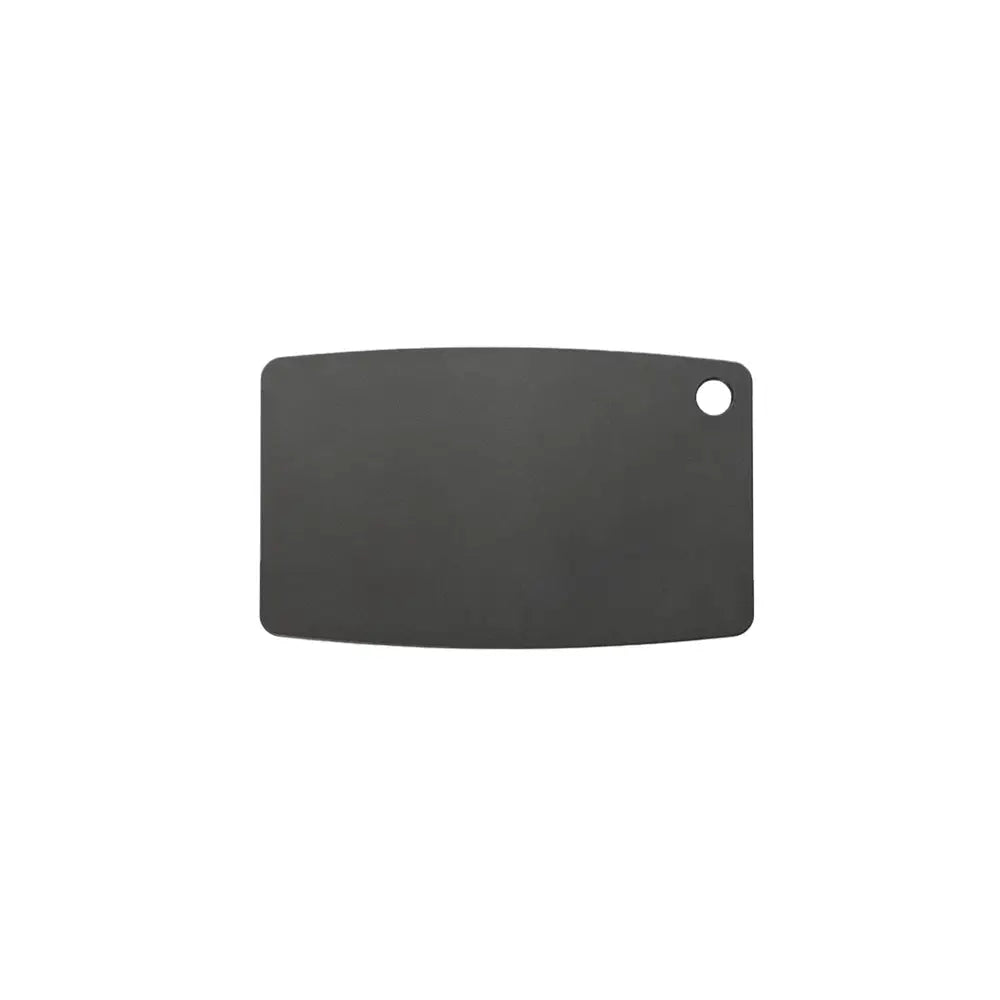Black cutting board with a round hole on a white background