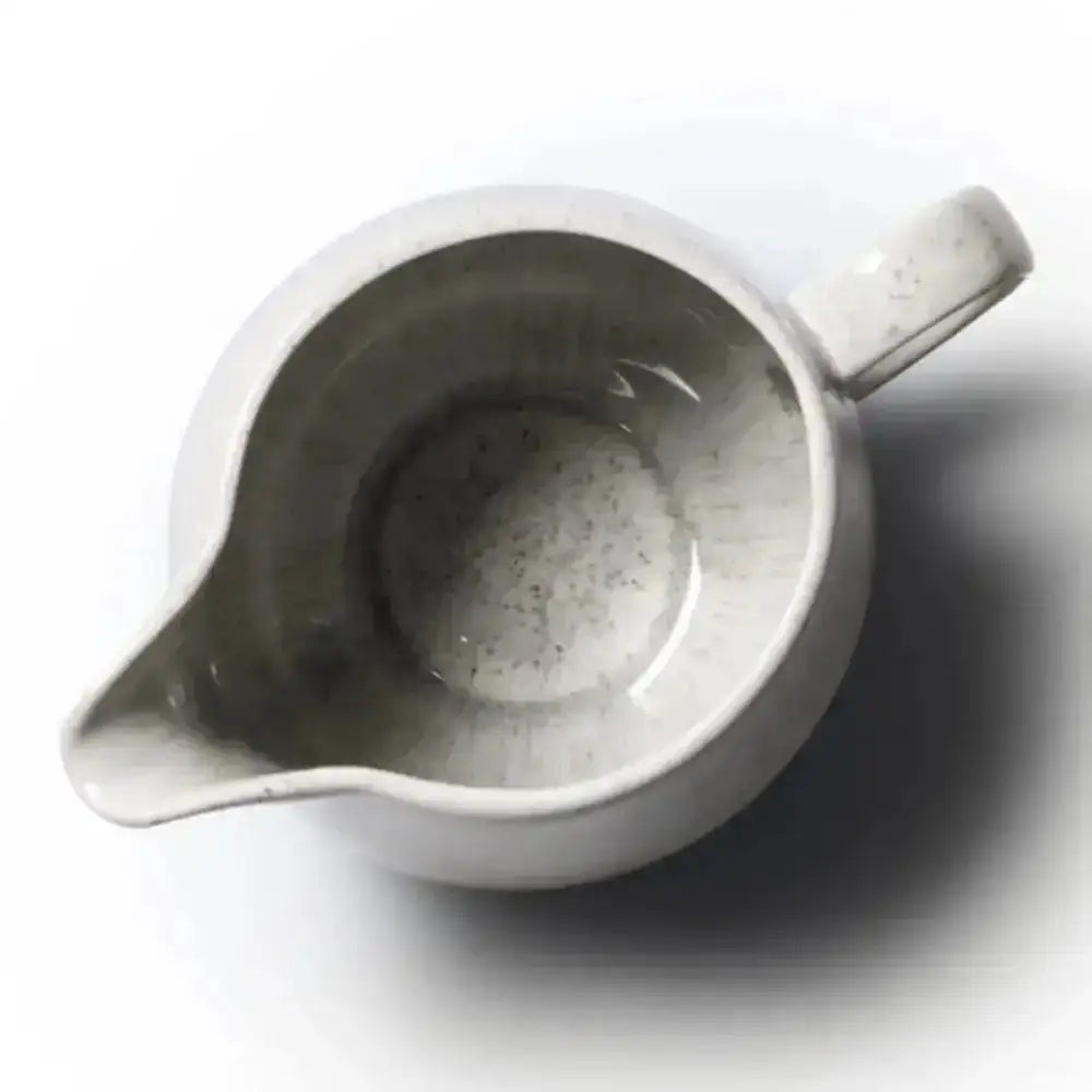 White ceramic pitcher on a white background
