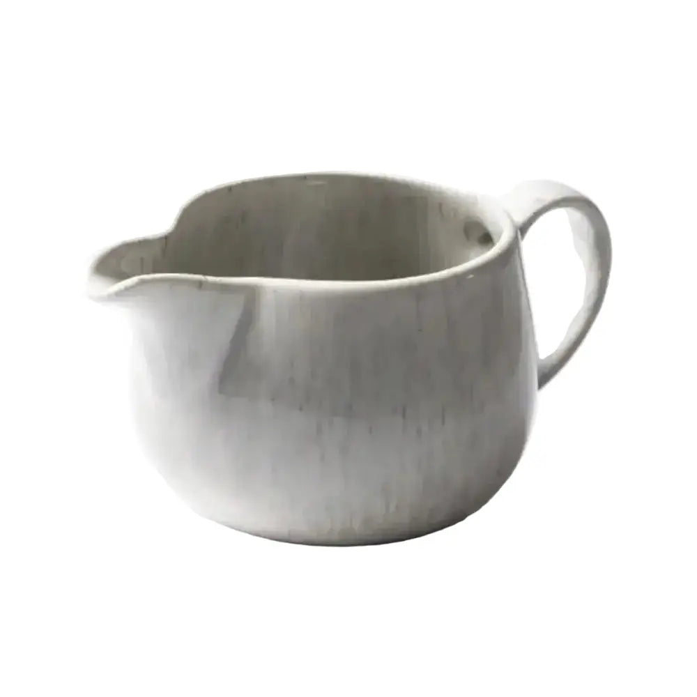 White ceramic pitcher on a white background