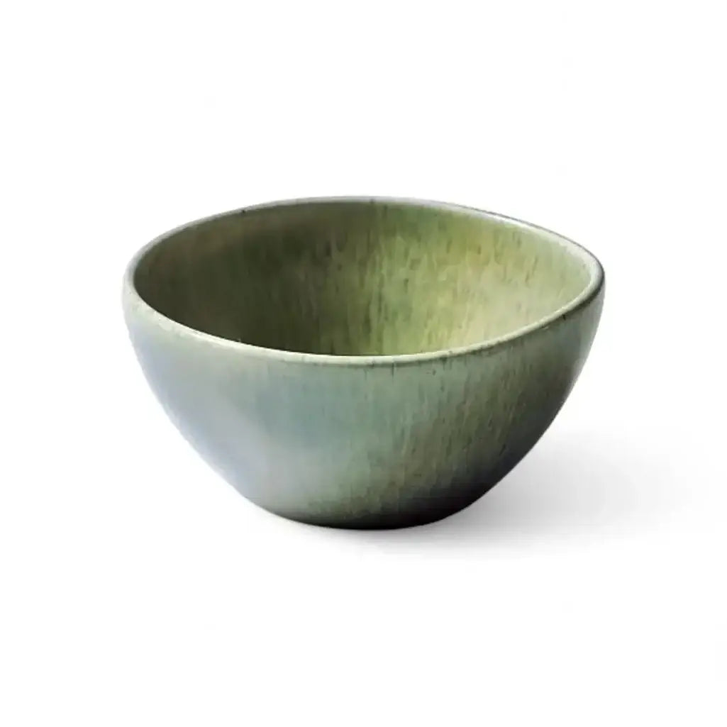 Green ceramic bowl on a white background